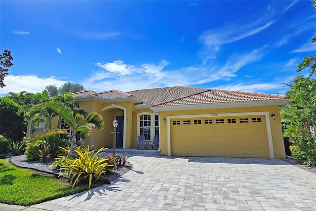 mediterranean / spanish home with a garage