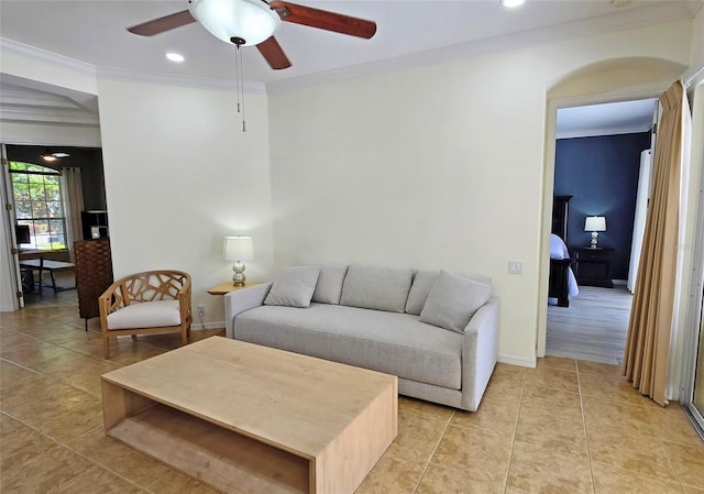 tiled living room with crown molding and ceiling fan