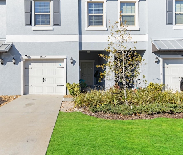 exterior space featuring a lawn and a garage