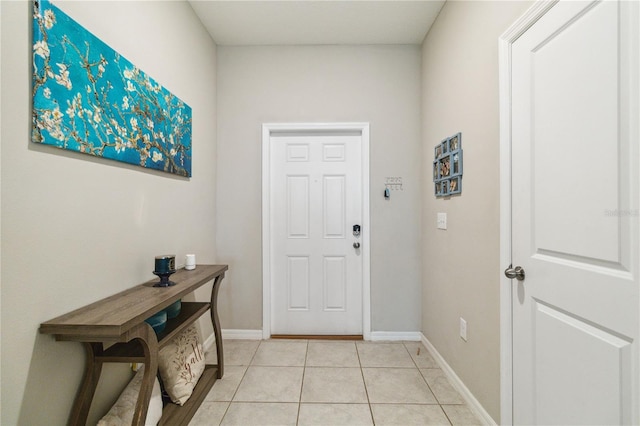 doorway to outside with light tile patterned floors