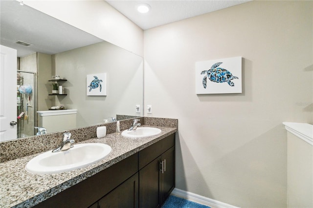 bathroom with a shower with door and vanity