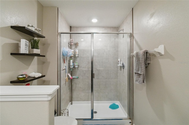 bathroom with a shower with door