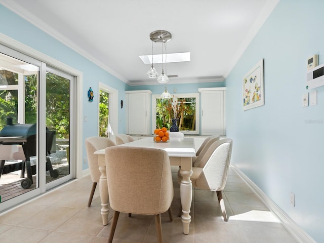 dining area with light tile patterned flooring, ornamental molding, and a skylight