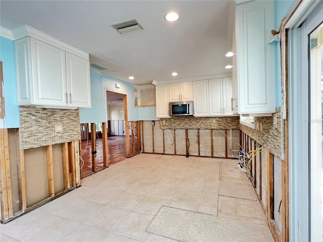 kitchen featuring white cabinets and decorative backsplash