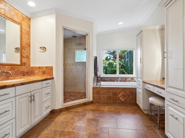 bathroom featuring plus walk in shower, vanity, and crown molding