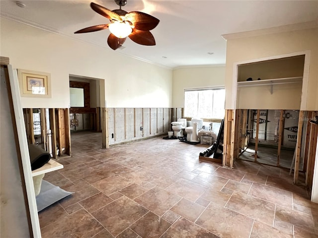 unfurnished room with ceiling fan and ornamental molding