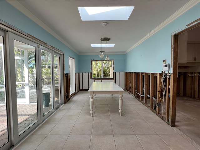 interior space with ornamental molding, light tile patterned floors, and a skylight