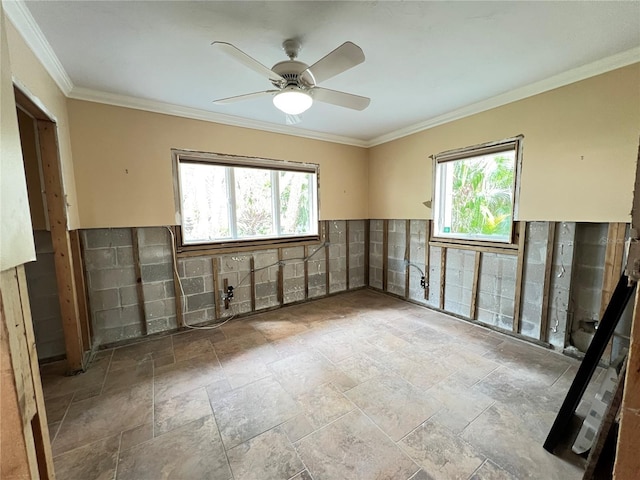 unfurnished room featuring ceiling fan, a healthy amount of sunlight, and ornamental molding