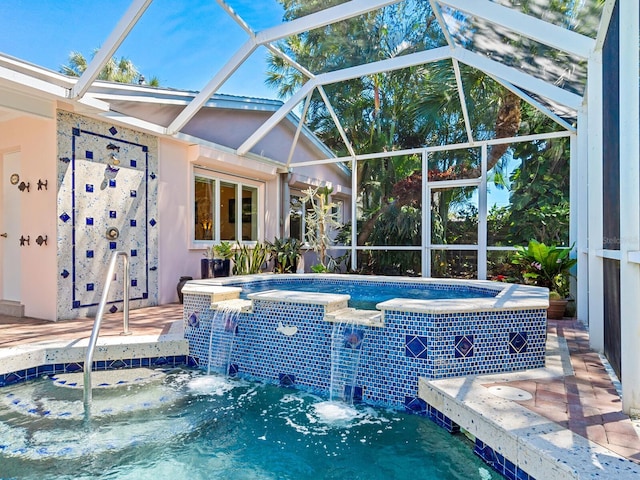 view of pool with pool water feature, a hot tub, and a lanai