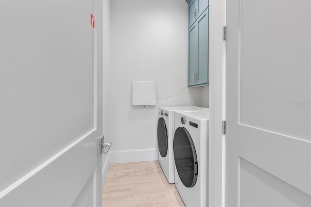 laundry area with cabinets and washing machine and clothes dryer