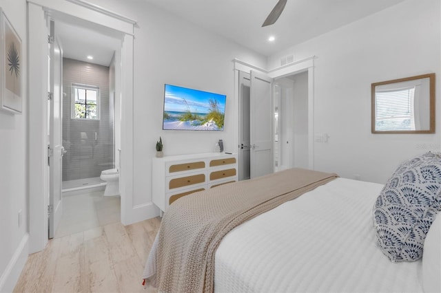 bedroom featuring ceiling fan and ensuite bath