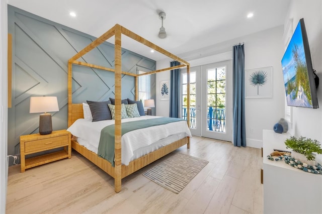 bedroom featuring wood-type flooring and access to outside