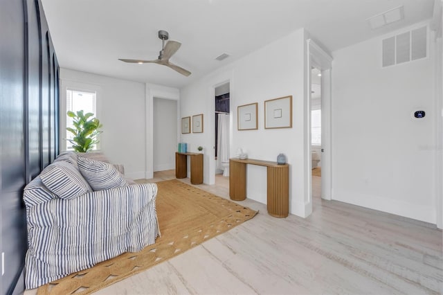 living room with ceiling fan and light hardwood / wood-style floors