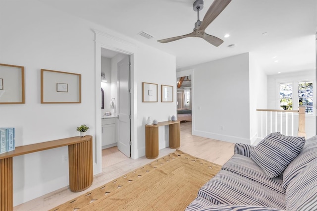 living room with light hardwood / wood-style flooring and ceiling fan