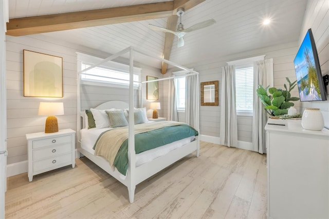 bedroom featuring beam ceiling, ceiling fan, and light wood-type flooring