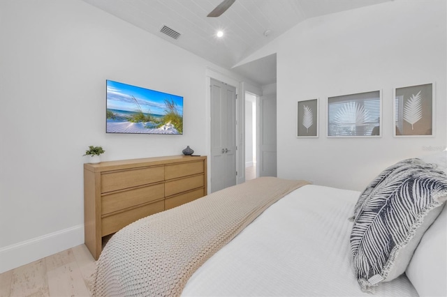 bedroom featuring ceiling fan, light wood-type flooring, and lofted ceiling