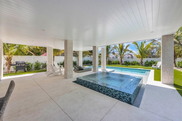 view of swimming pool featuring area for grilling and a patio area