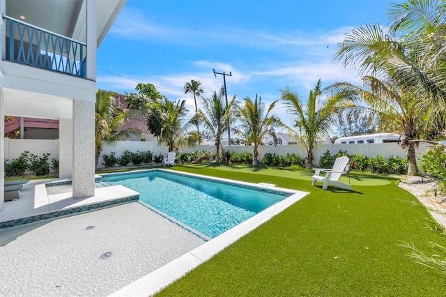 view of swimming pool with a lawn