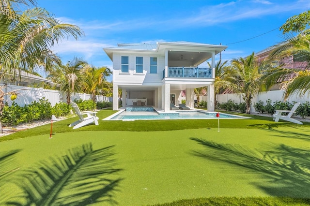 back of house with a patio, a balcony, ceiling fan, and a fenced in pool