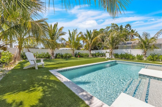 view of swimming pool featuring a yard