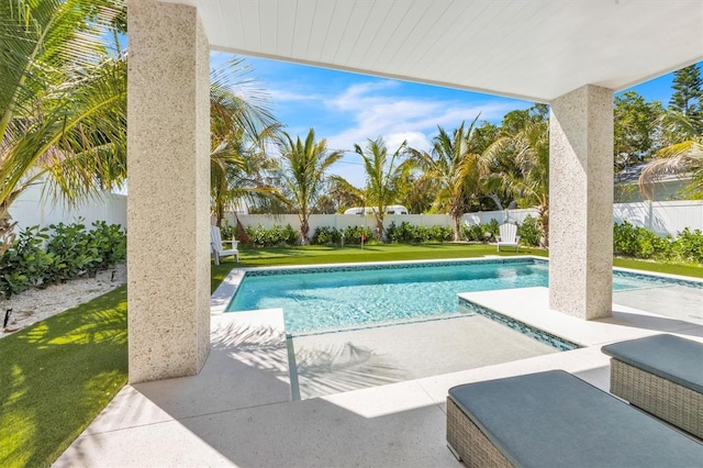 view of swimming pool with a lawn