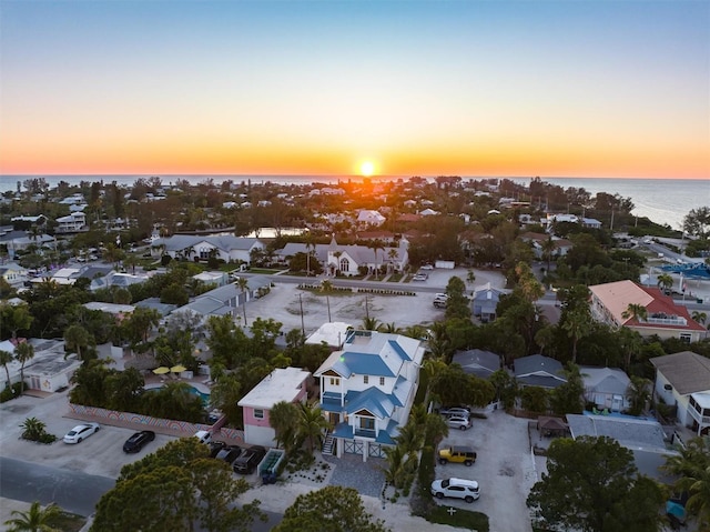 aerial view at dusk with a water view