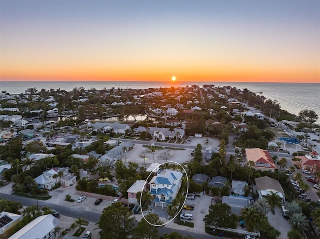 aerial view at dusk with a water view