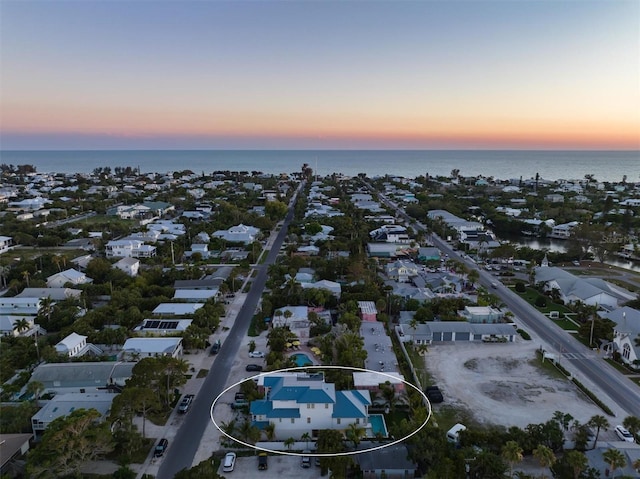 aerial view at dusk with a water view