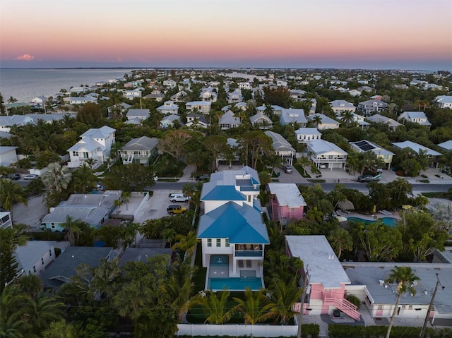 aerial view at dusk with a water view