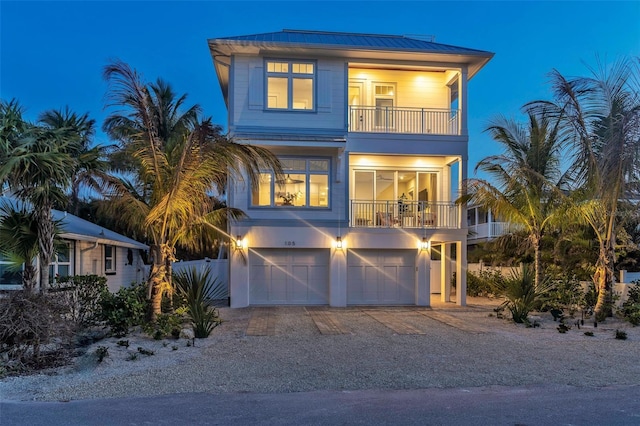 beach home with a balcony and a garage