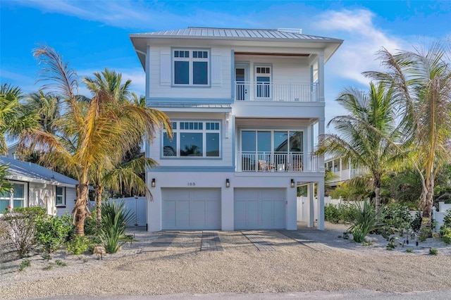 coastal inspired home with a balcony and a garage