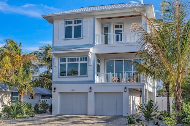 view of front of home featuring a balcony and a garage