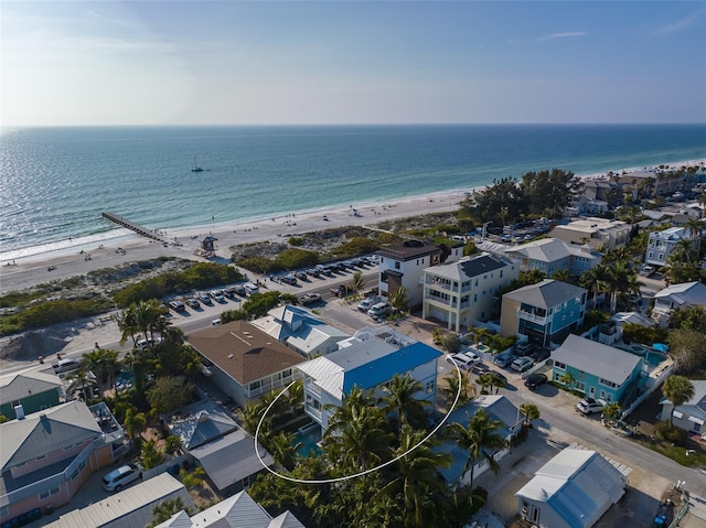 drone / aerial view with a water view and a beach view