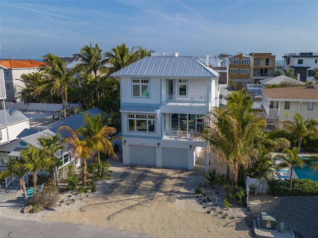 view of front of home with a garage and a balcony