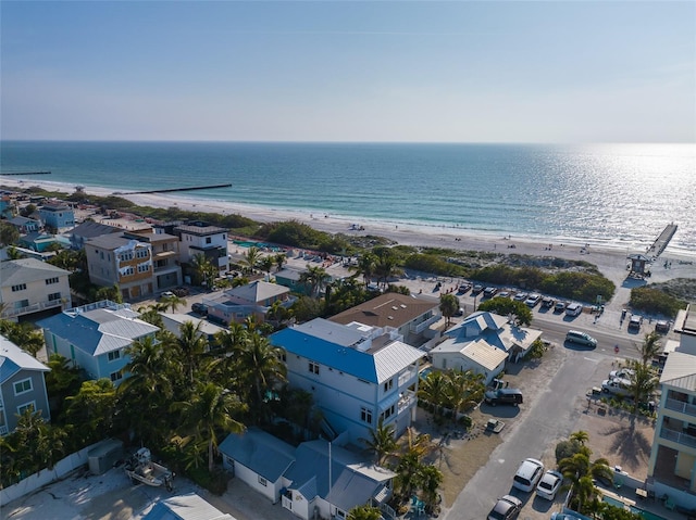 birds eye view of property featuring a water view and a beach view