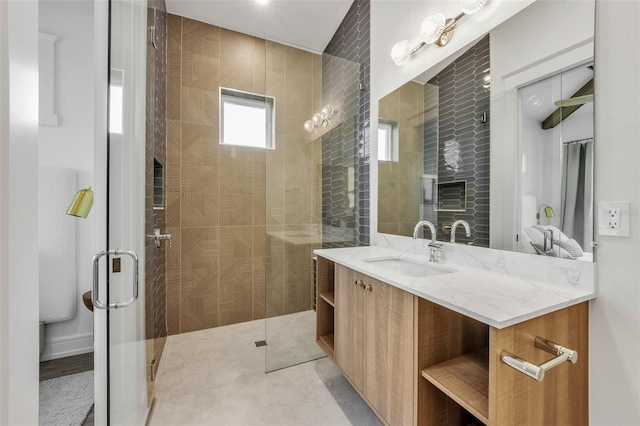 bathroom featuring tile patterned flooring, vanity, and an enclosed shower