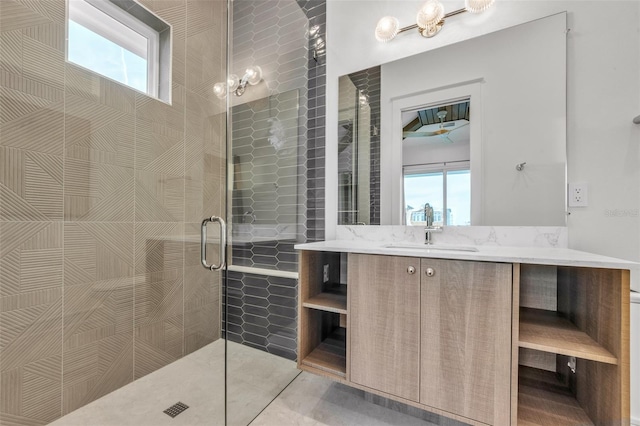 bathroom featuring vanity, a healthy amount of sunlight, and an enclosed shower