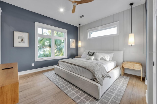 bedroom with ceiling fan and light hardwood / wood-style flooring