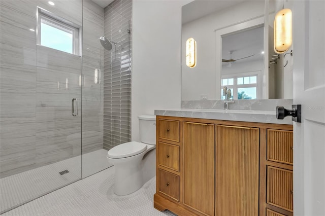 bathroom with ceiling fan, walk in shower, tile patterned floors, toilet, and vanity