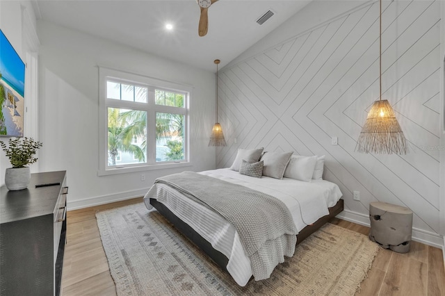 bedroom with vaulted ceiling, light hardwood / wood-style flooring, and ceiling fan