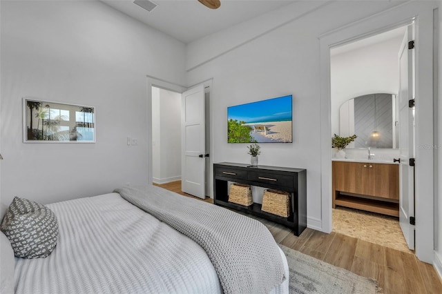 bedroom with ensuite bathroom and ceiling fan