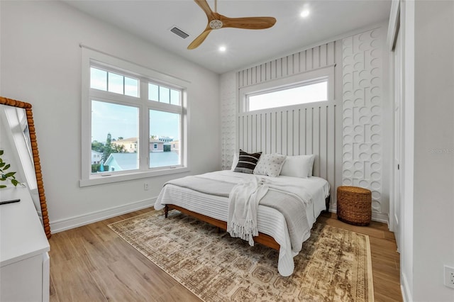 bedroom with ceiling fan and light wood-type flooring