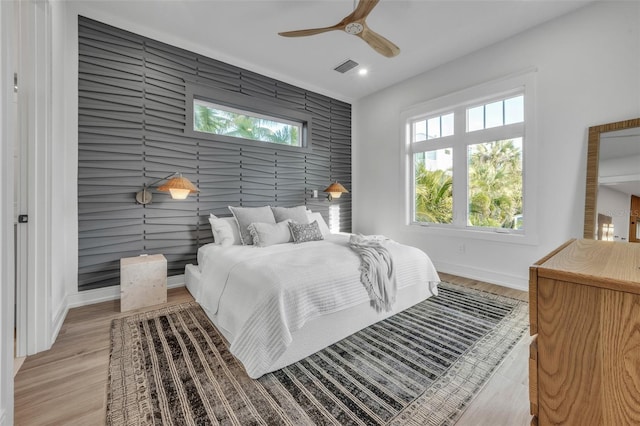 bedroom featuring light hardwood / wood-style flooring and ceiling fan