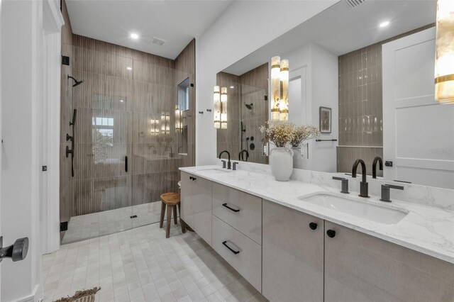 bathroom featuring vanity, a shower with shower door, and tile walls