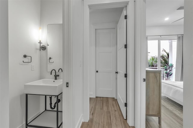 bathroom with wood-type flooring