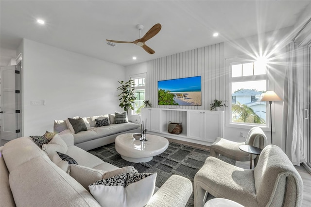 living room with ceiling fan and wood-type flooring