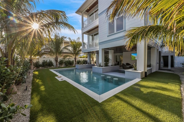 view of pool featuring a lawn, outdoor lounge area, and a patio