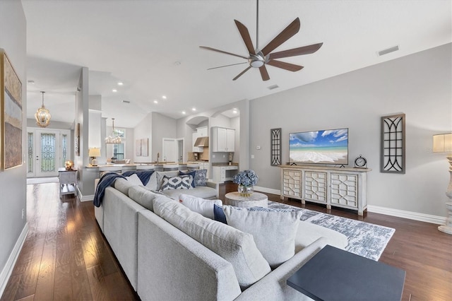 living room with vaulted ceiling, ceiling fan, and dark hardwood / wood-style flooring