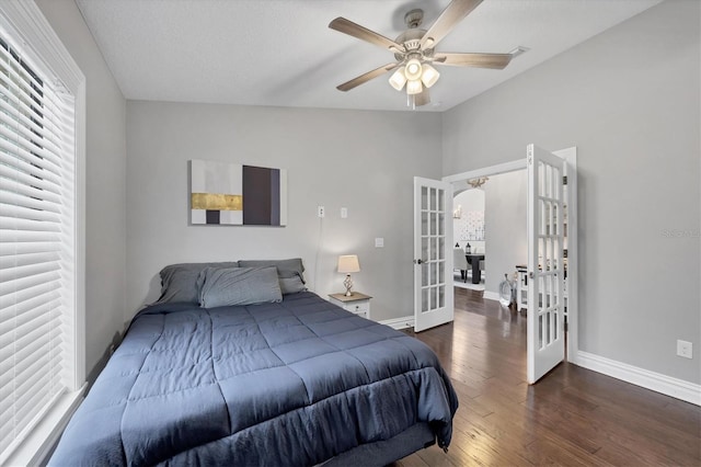 bedroom featuring ceiling fan, dark hardwood / wood-style flooring, and french doors