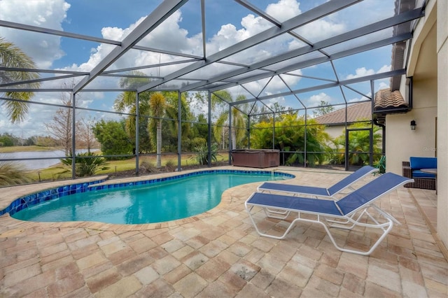 view of swimming pool featuring a patio area, a lanai, a hot tub, and a water view